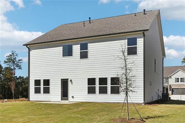 back of property featuring a lawn and central AC unit