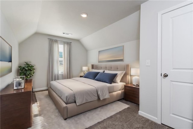 bedroom featuring carpet and vaulted ceiling