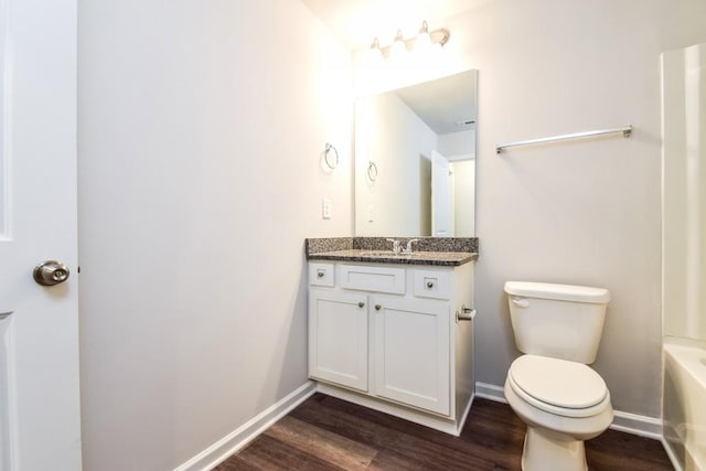 bathroom with wood-type flooring, vanity, and toilet