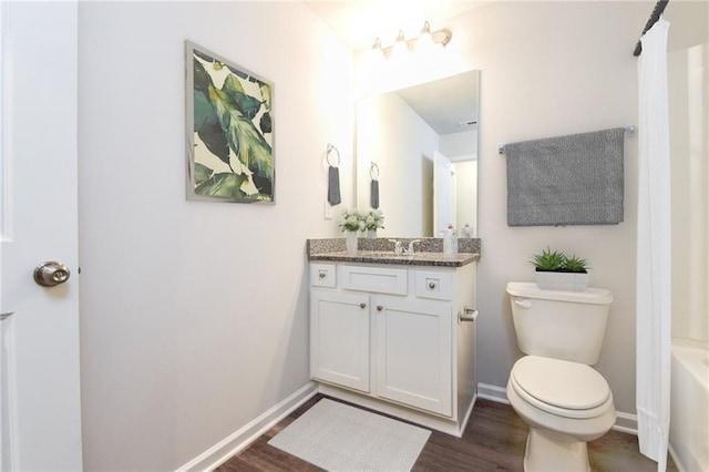 full bathroom featuring vanity, hardwood / wood-style flooring, toilet, and shower / bath combo with shower curtain