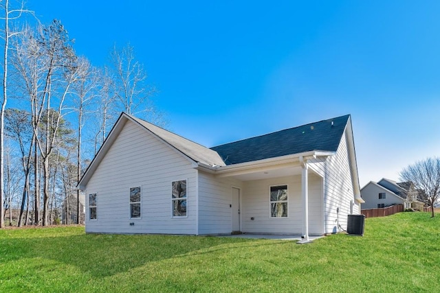 back of property featuring a yard and central AC unit