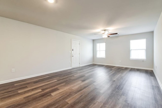 empty room featuring ceiling fan and dark hardwood / wood-style floors