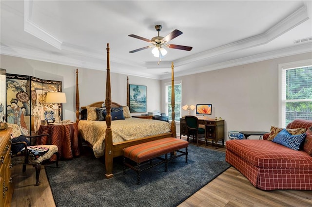 7537 Brookstone Cir, Flowery Branch, GA 30542 - bedroom featuring a raised ceiling, crown molding, wood finished floors, and a ceiling fan