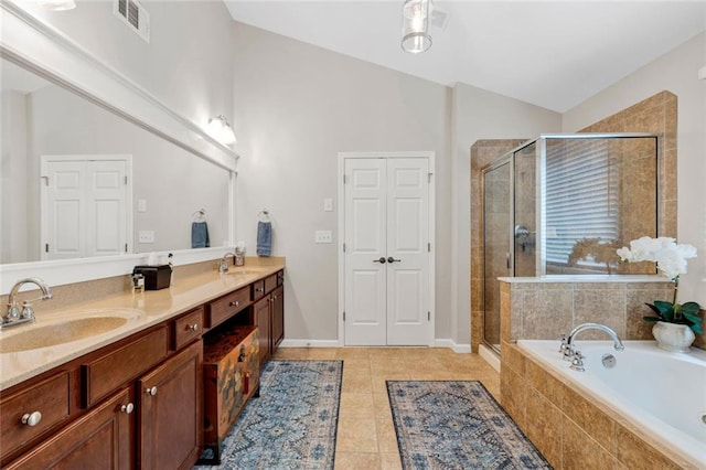 7537 Brookstone Cir, Flowery Branch, GA 30542 - full bath featuring double vanity, a bath, a stall shower, vaulted ceiling, and tile patterned flooring