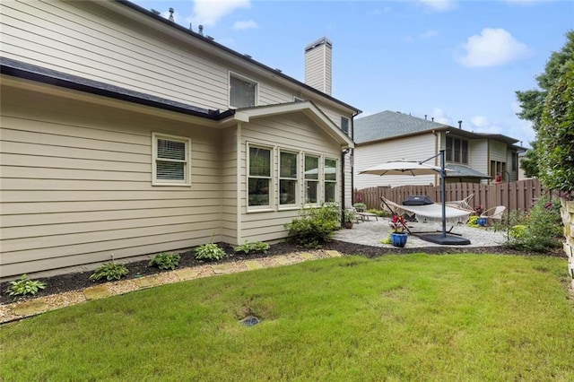 7537 Brookstone Cir, Flowery Branch, GA 30542 - back of house featuring a patio and a chimney