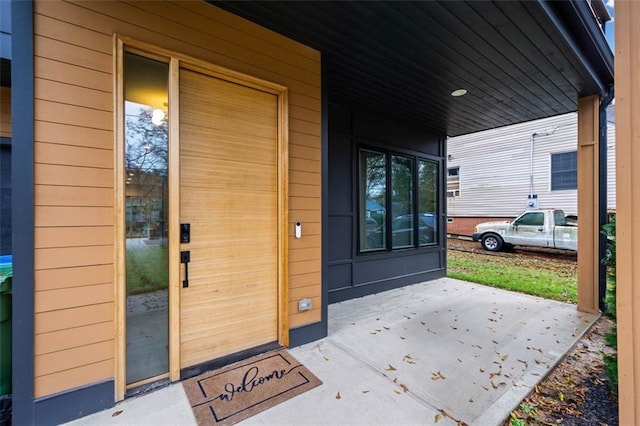 view of exterior entry with a porch