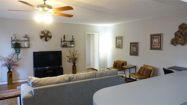 living room with ceiling fan and parquet flooring