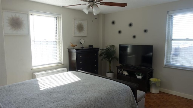 bedroom featuring dark parquet flooring and ceiling fan