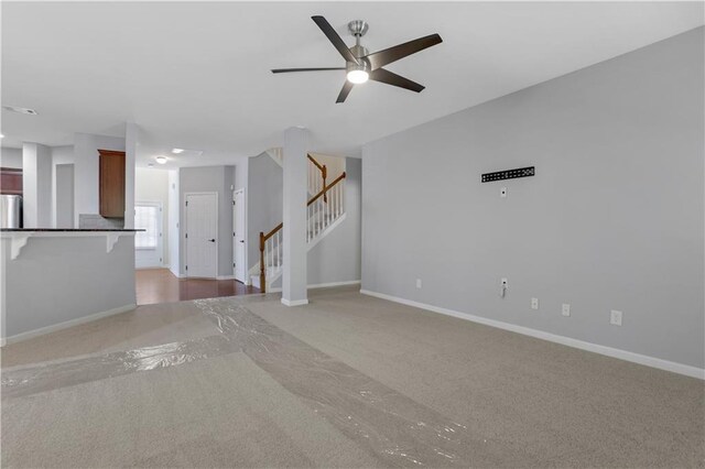 unfurnished living room with carpet flooring and ceiling fan