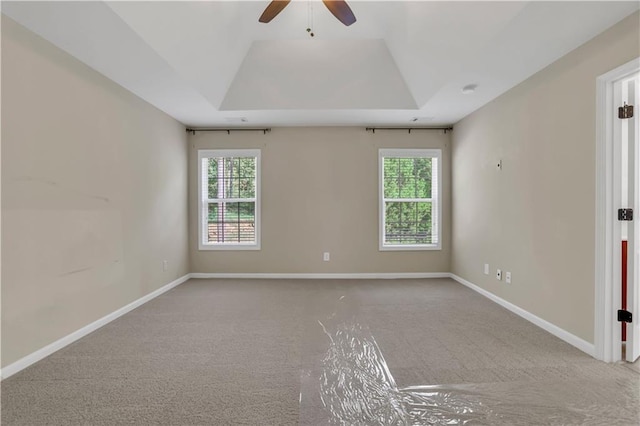 carpeted spare room with ceiling fan and a healthy amount of sunlight