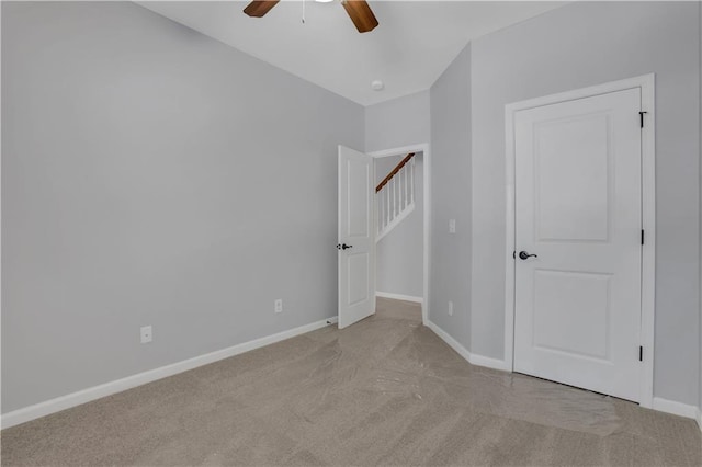 unfurnished room featuring ceiling fan and light carpet