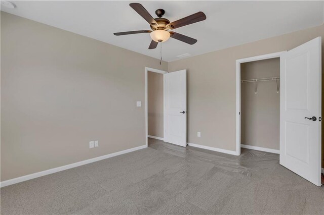 unfurnished bedroom with ceiling fan, light colored carpet, and a closet