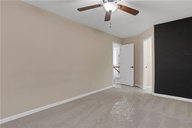 unfurnished room with ceiling fan and light colored carpet