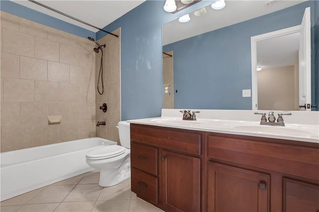 full bathroom featuring tile patterned floors, vanity, toilet, and tiled shower / bath