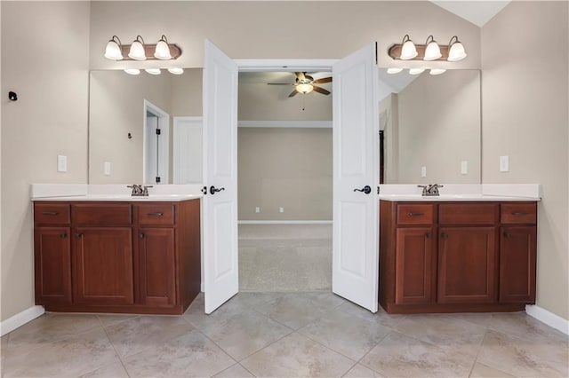 bathroom with tile patterned floors, ceiling fan, vanity, and vaulted ceiling