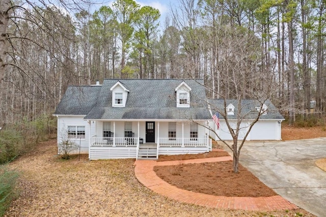 cape cod home with a garage and covered porch