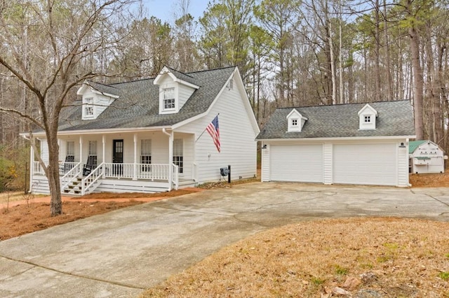 cape cod-style house with a porch and a garage