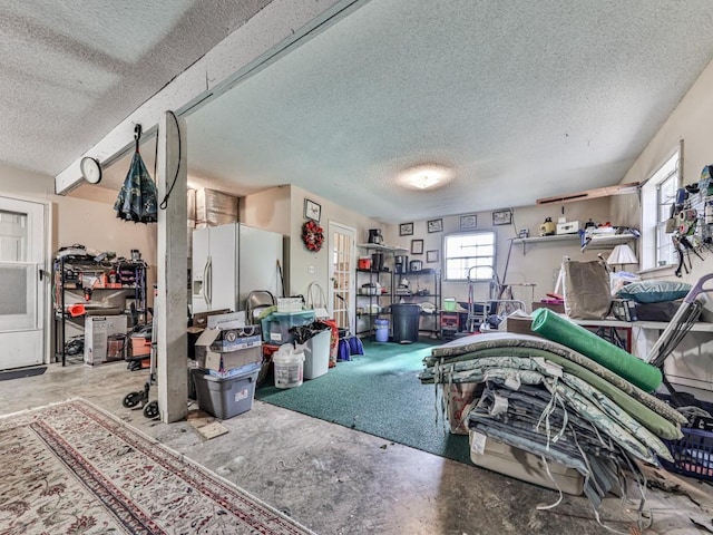 garage with white refrigerator with ice dispenser