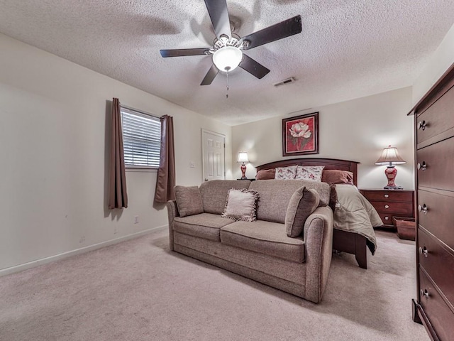 carpeted bedroom with a textured ceiling and ceiling fan