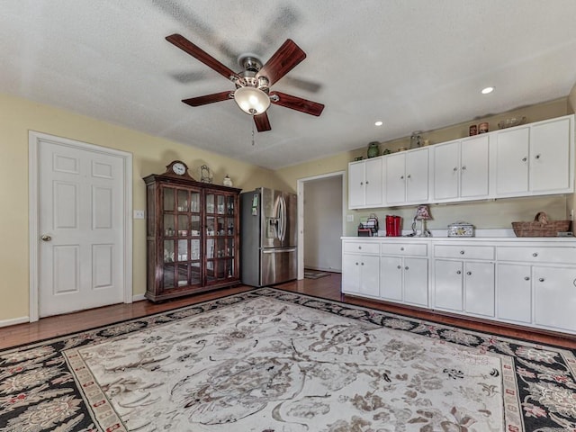 kitchen with white cabinetry, ceiling fan, a textured ceiling, and stainless steel fridge