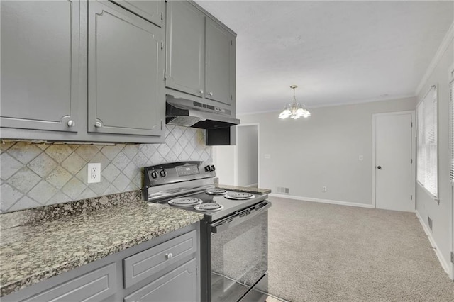 kitchen with gray cabinets, tasteful backsplash, ornamental molding, light colored carpet, and black / electric stove