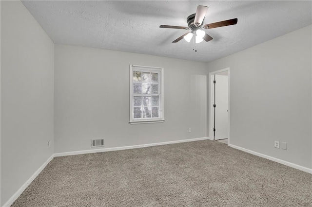 spare room with ceiling fan, carpet floors, and a textured ceiling