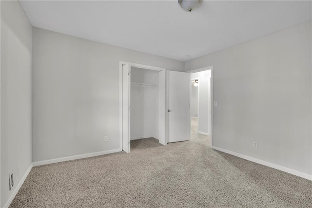 unfurnished bedroom with carpet floors and a closet