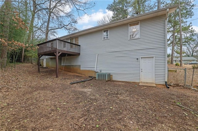 back of property featuring a wooden deck and central AC