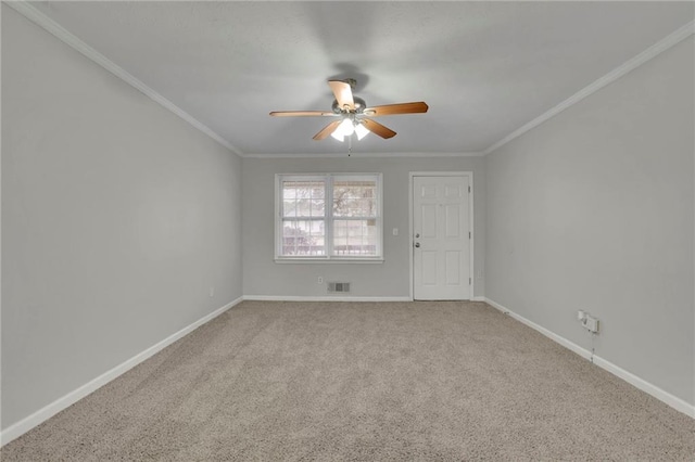 carpeted empty room with ornamental molding and ceiling fan