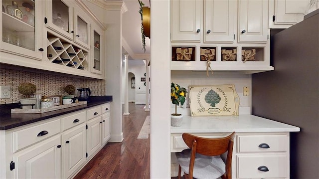 kitchen featuring white cabinetry, dark hardwood / wood-style flooring, and decorative backsplash