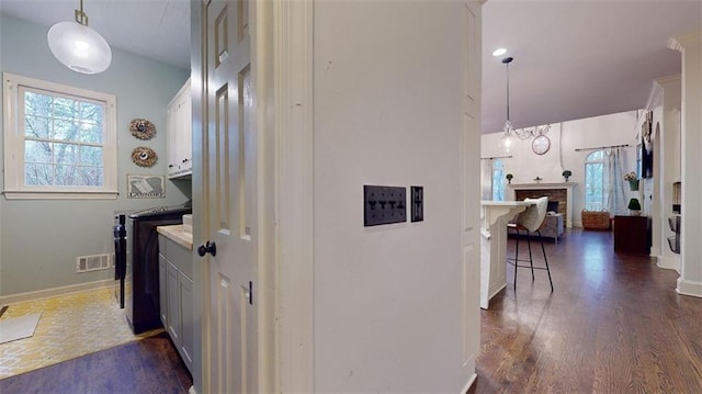 washroom with dark wood-type flooring and a brick fireplace