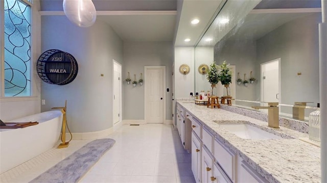 bathroom with ornamental molding, dual vanity, tile patterned floors, and a bathtub