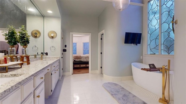 bathroom with tile patterned floors, a washtub, and dual bowl vanity