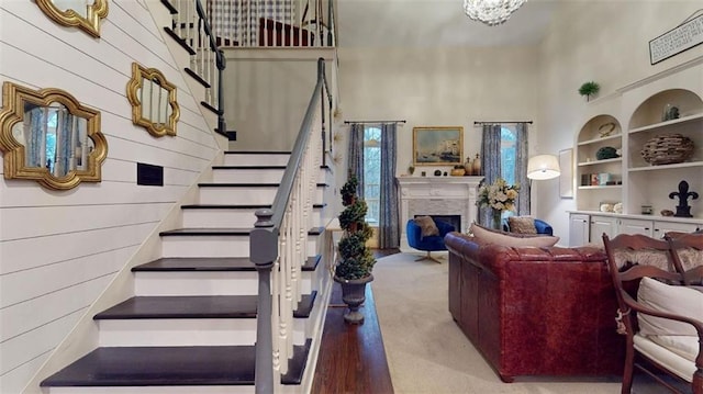 carpeted living room featuring a high ceiling