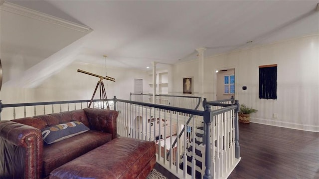 living area with dark wood-type flooring, lofted ceiling, and ornamental molding