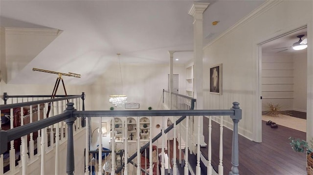 hall featuring a notable chandelier, hardwood / wood-style floors, and ornamental molding