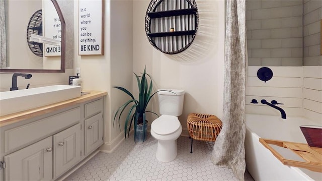 bathroom with vanity, tile patterned flooring, and toilet