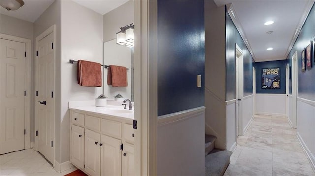 bathroom featuring vanity, crown molding, and tile patterned flooring