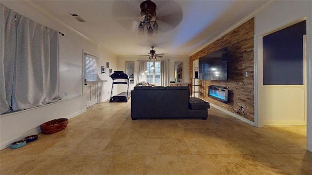 tiled living room featuring a stone fireplace, ceiling fan, and ornamental molding