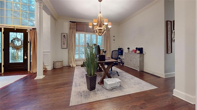 dining space featuring crown molding, a chandelier, dark hardwood / wood-style flooring, and ornate columns