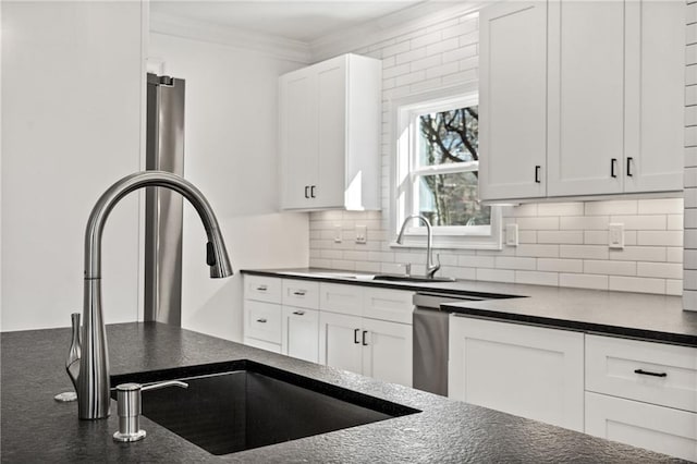 kitchen featuring ornamental molding, a sink, white cabinets, and decorative backsplash