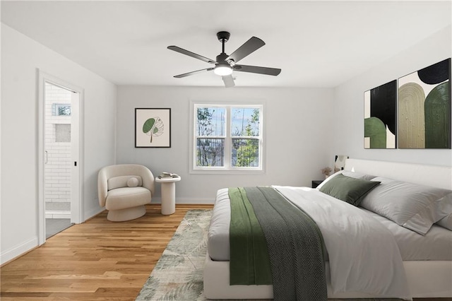 bedroom with a ceiling fan, baseboards, and wood finished floors