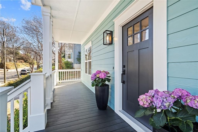 wooden terrace featuring covered porch