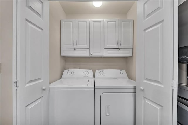 clothes washing area with cabinet space and washer and dryer