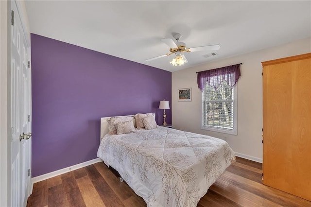 bedroom featuring visible vents, baseboards, and dark wood-style flooring