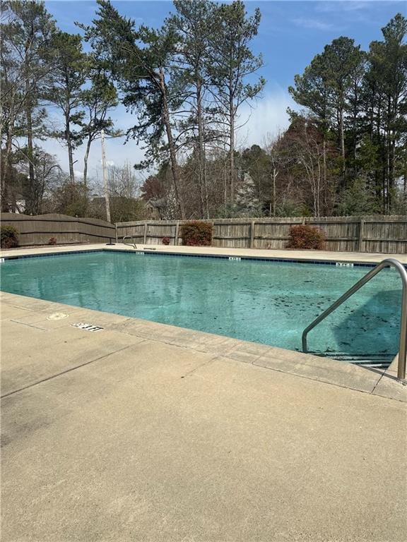 pool with a patio area and a fenced backyard