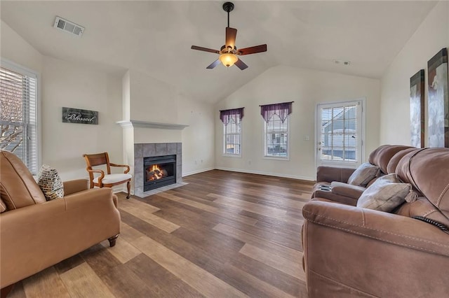 living room featuring visible vents, a ceiling fan, lofted ceiling, and wood finished floors