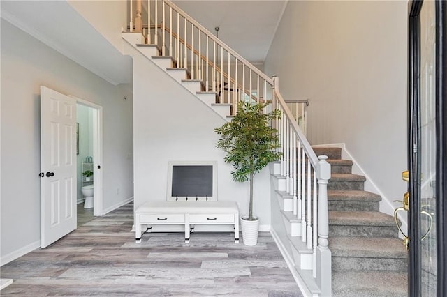 stairs featuring baseboards and wood finished floors