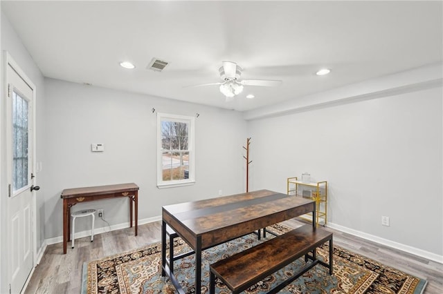 dining room with visible vents, baseboards, and wood finished floors