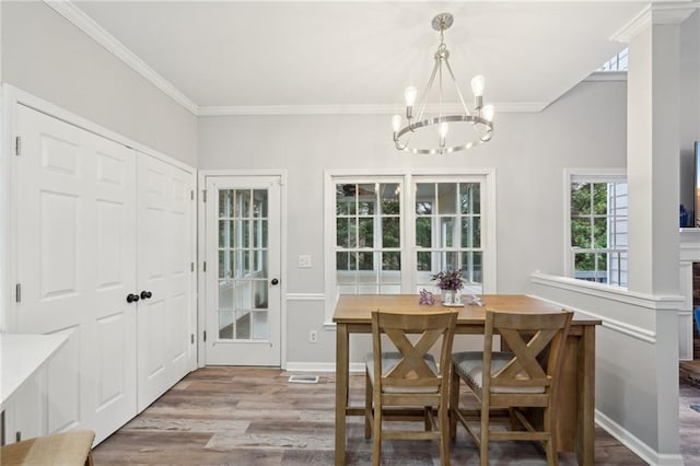 dining area with crown molding, baseboards, and wood finished floors